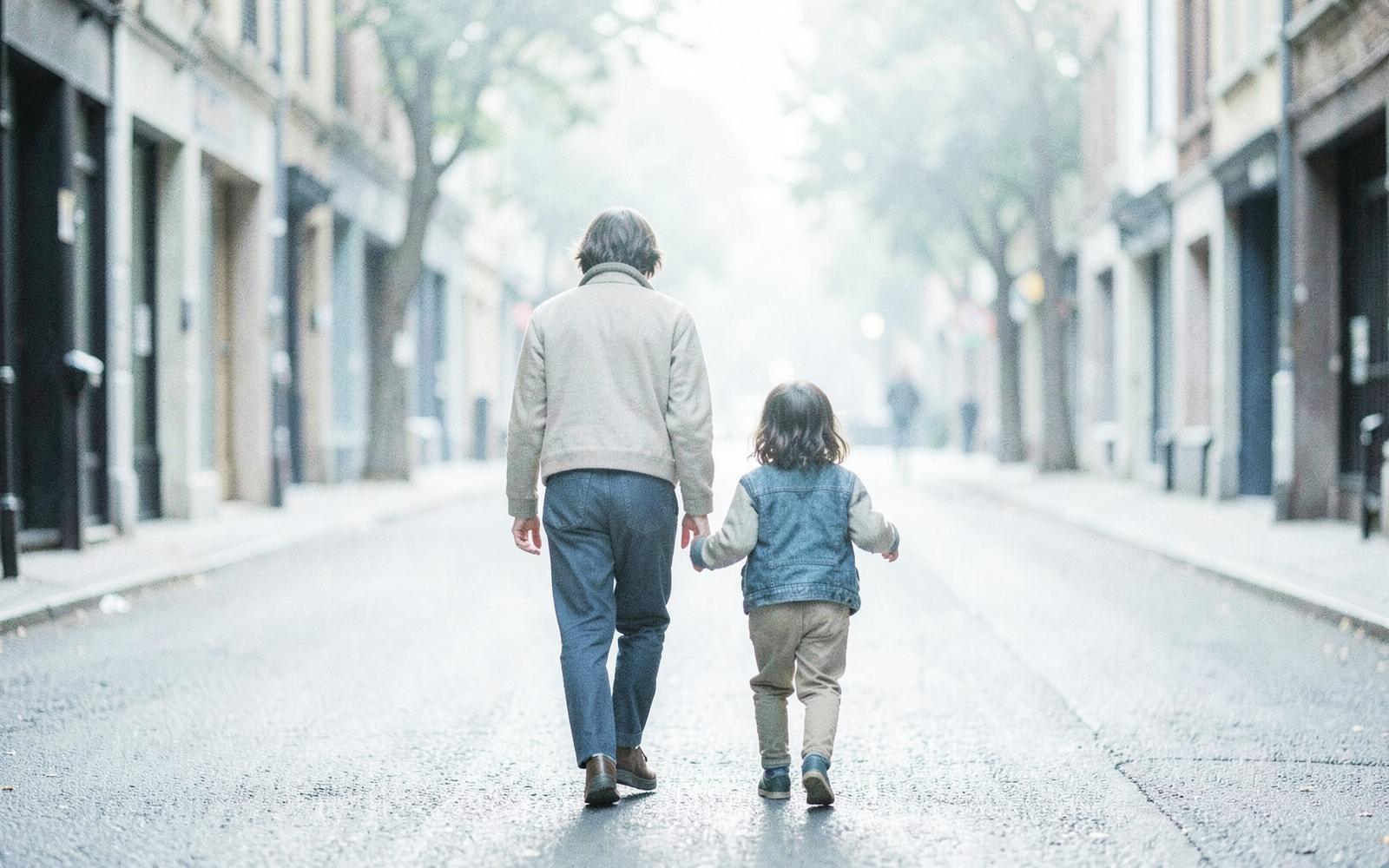 A parent and child walking together on a quiet morning street